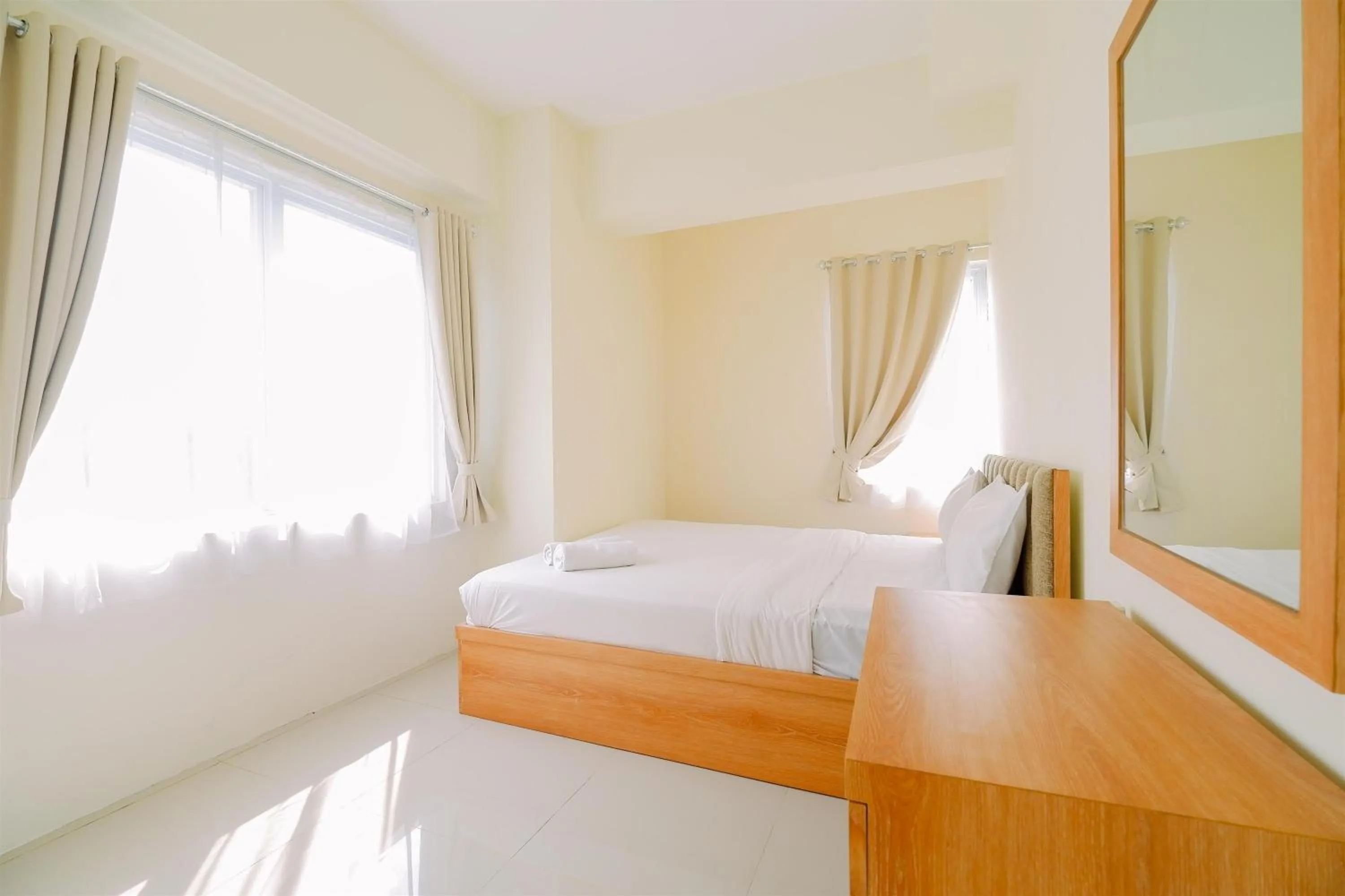 Bed in Warm and Cozy Living 2BR Bogorienze Apartment By Travelio