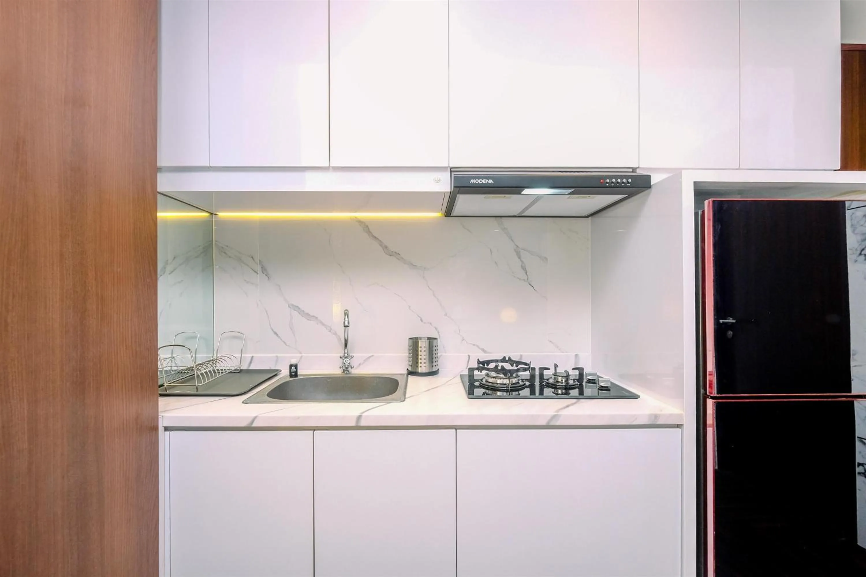 kitchen in Good Deal 2BR at High Floor Transpark Cibubur Apartment By Travelio