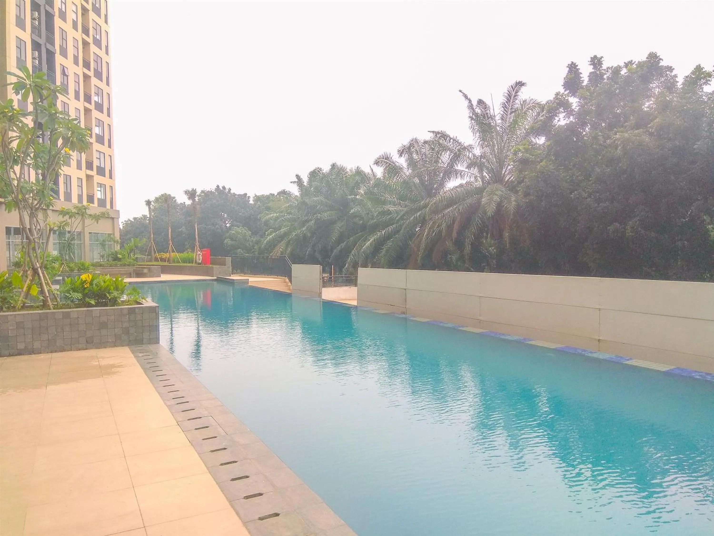 Swimming pool in Good Deal 2BR at High Floor Transpark Cibubur Apartment By Travelio