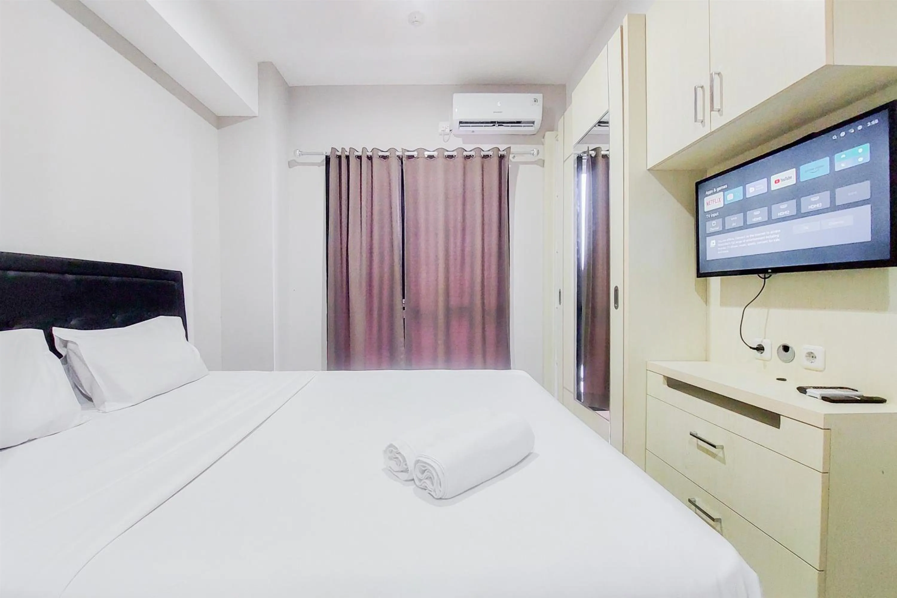 Photo of the whole room, Bed in Comfy and Modern Studio Room The Ayoma Apartment By Travelio