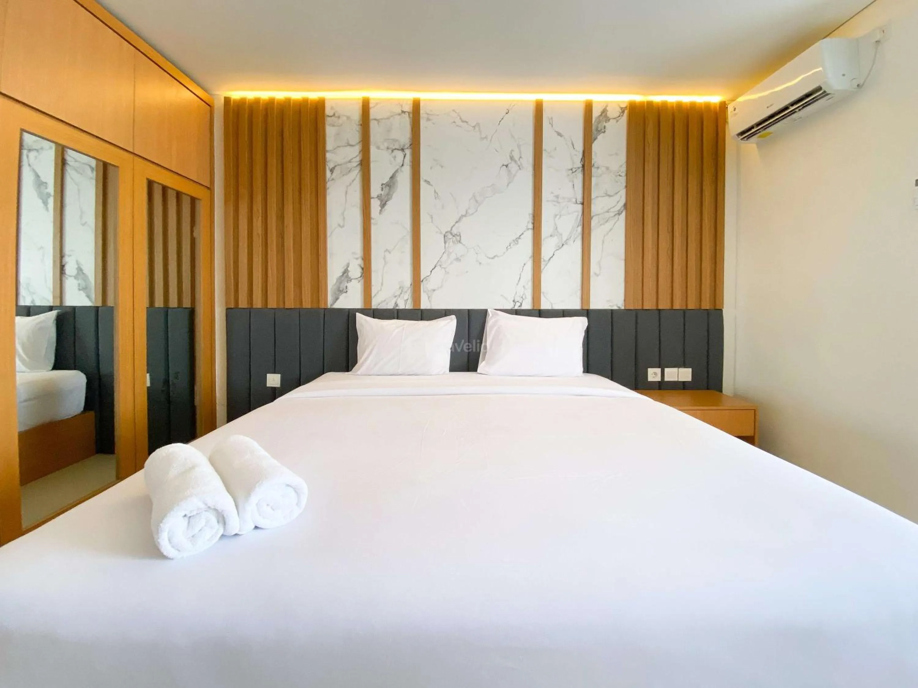 Bed in Homey and Strategic Studio (No Kitchen) at Sentraland Semarang Apartment By Travelio