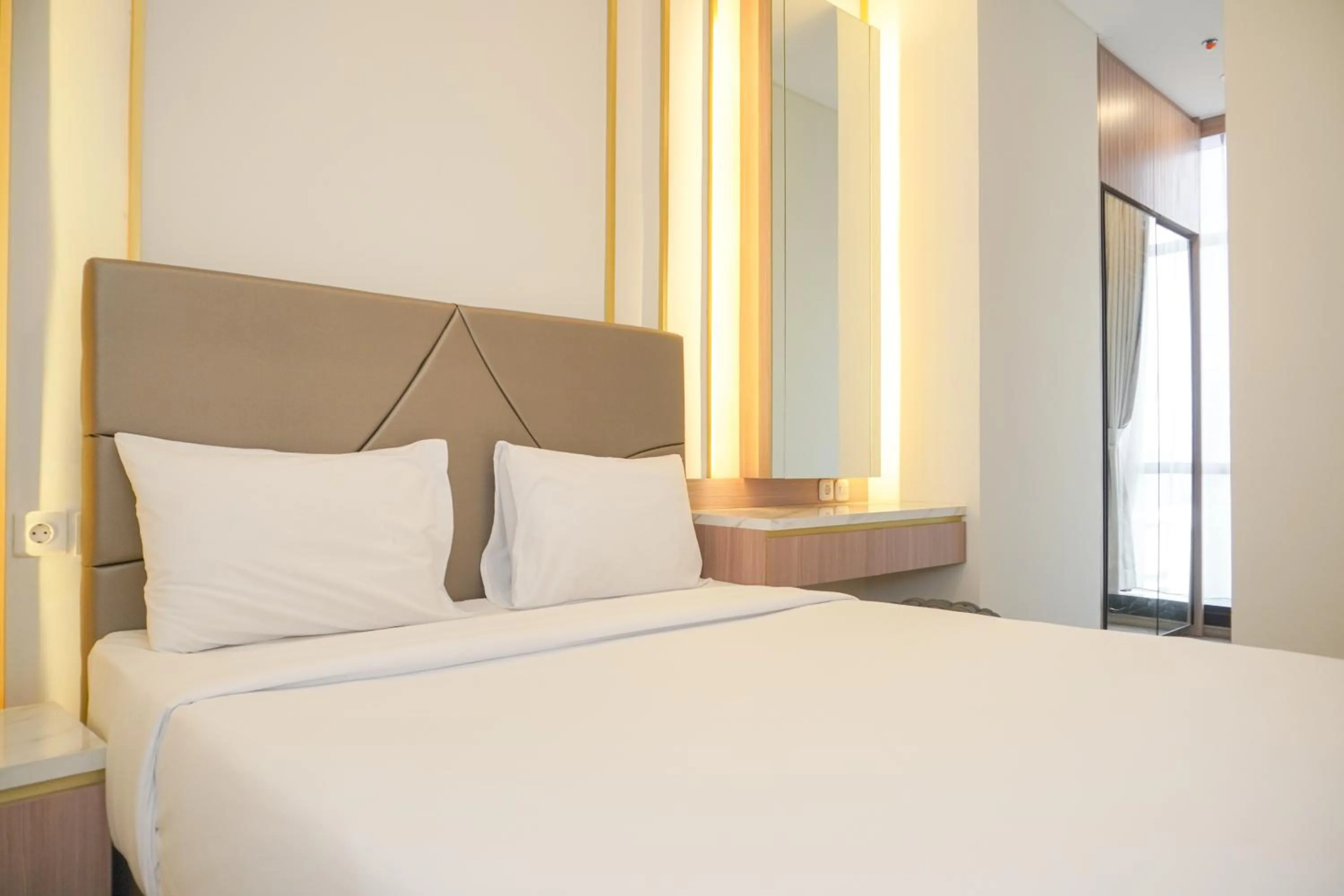Bed in Comfort and Elegant 2BR Sudirman Suites Apartment By Travelio