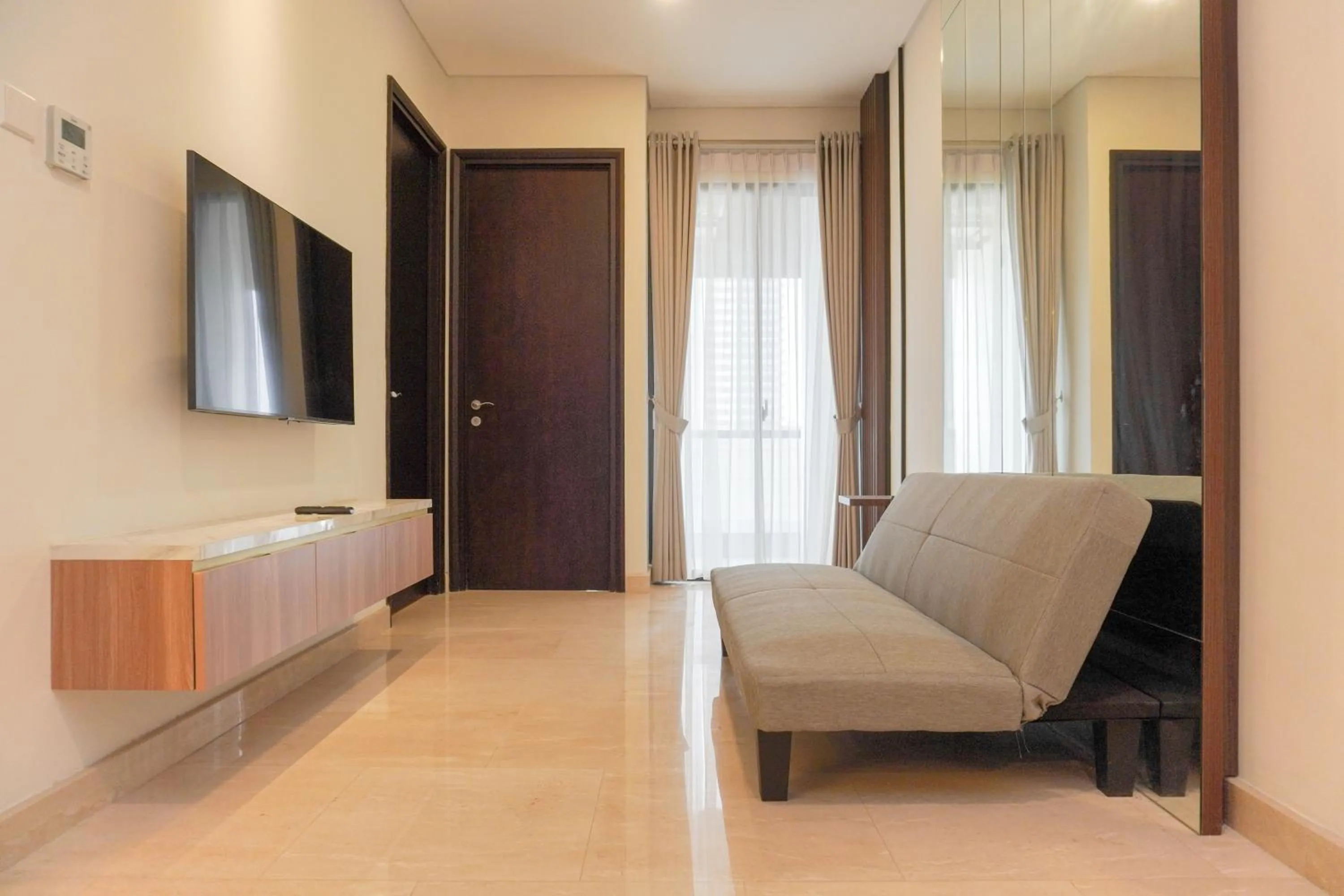 Living room in Comfort and Elegant 2BR Sudirman Suites Apartment By Travelio