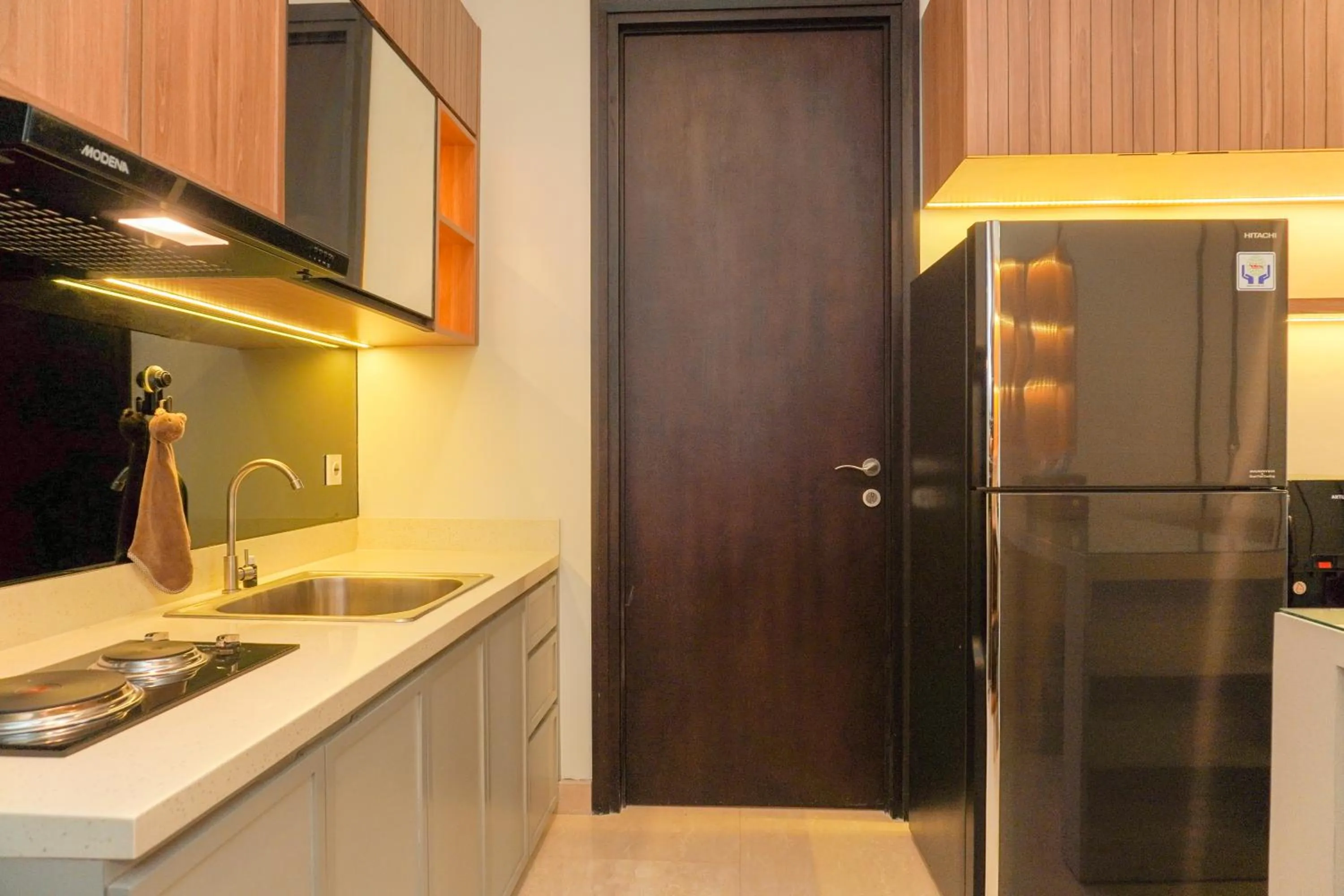 Kitchen or kitchenette in Comfort and Elegant 2BR Sudirman Suites Apartment By Travelio