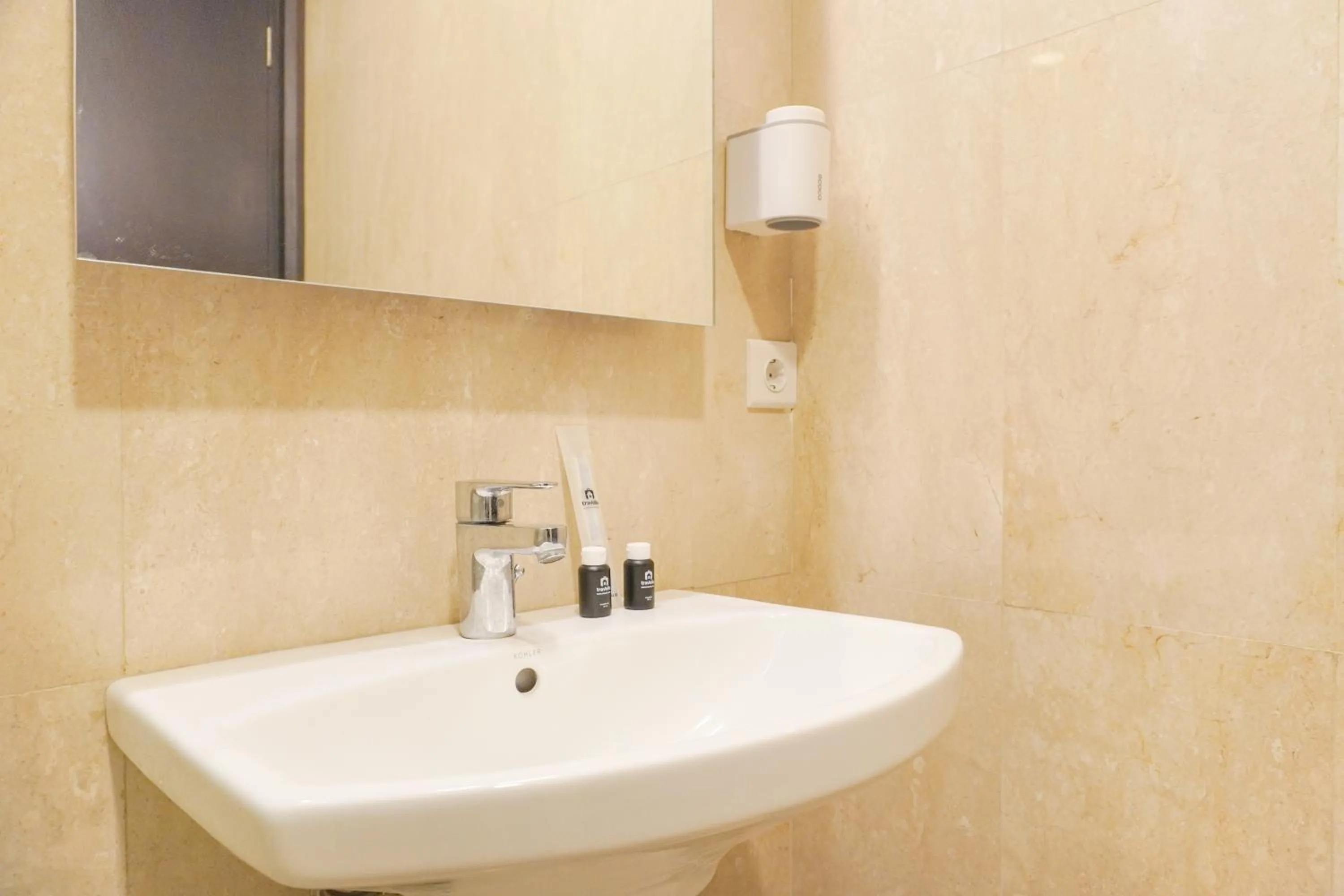 Bathroom in Comfort and Elegant 2BR Sudirman Suites Apartment By Travelio