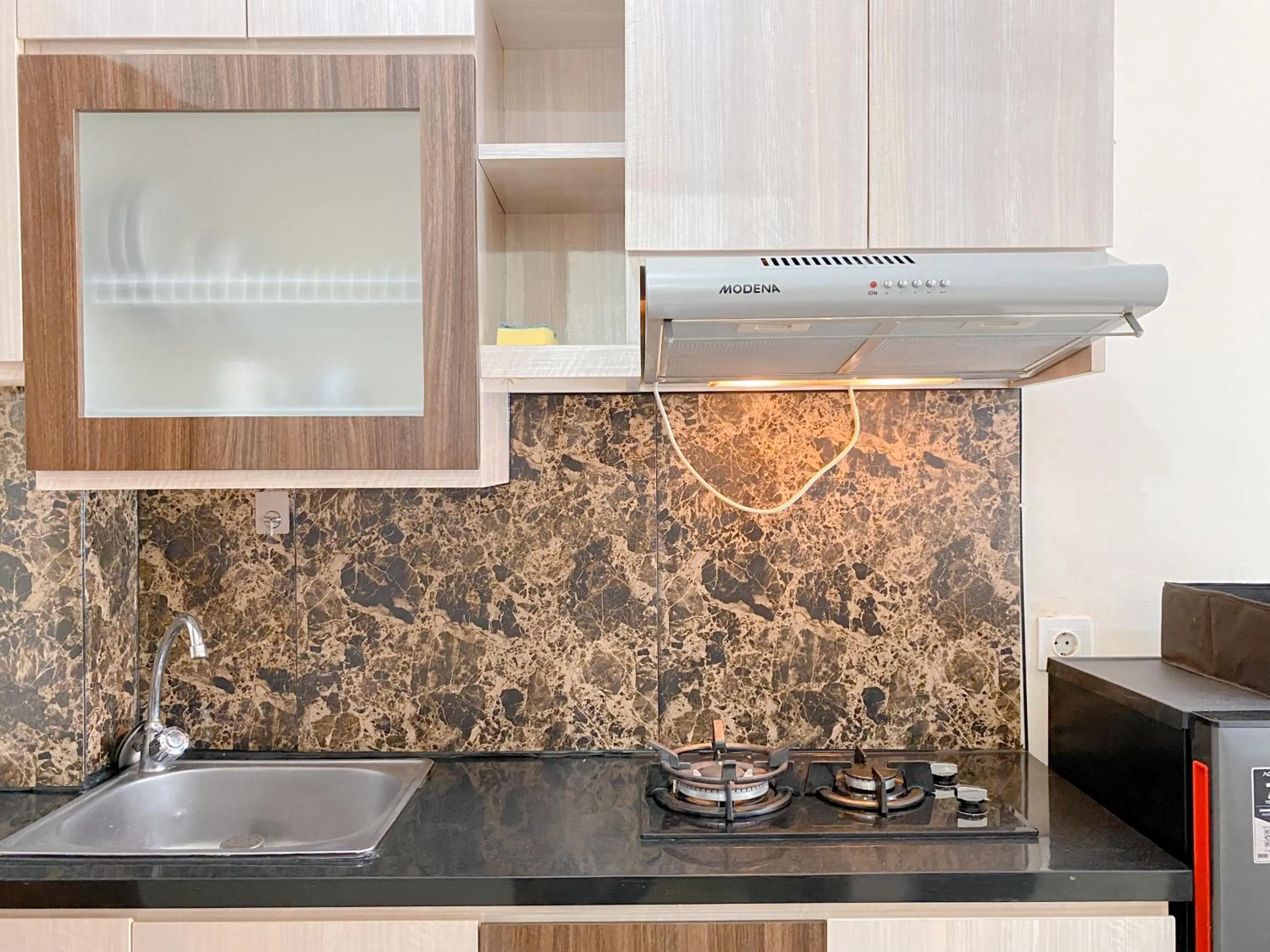 Kitchen or kitchenette in Modern Look and Comfy Studio Tifolia Apartment By Travelio