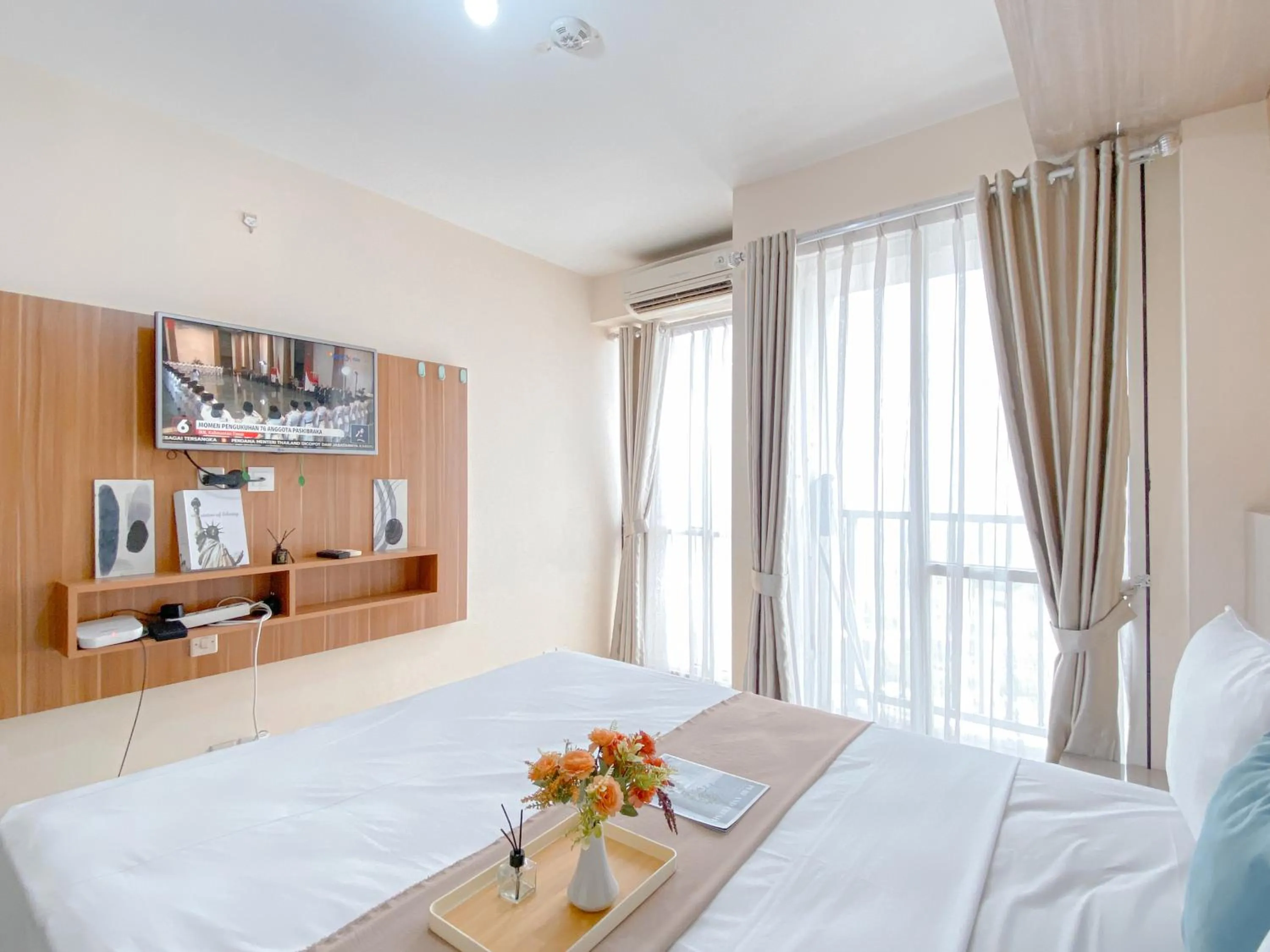 Bed in Modern Look and Comfy Studio Tifolia Apartment By Travelio