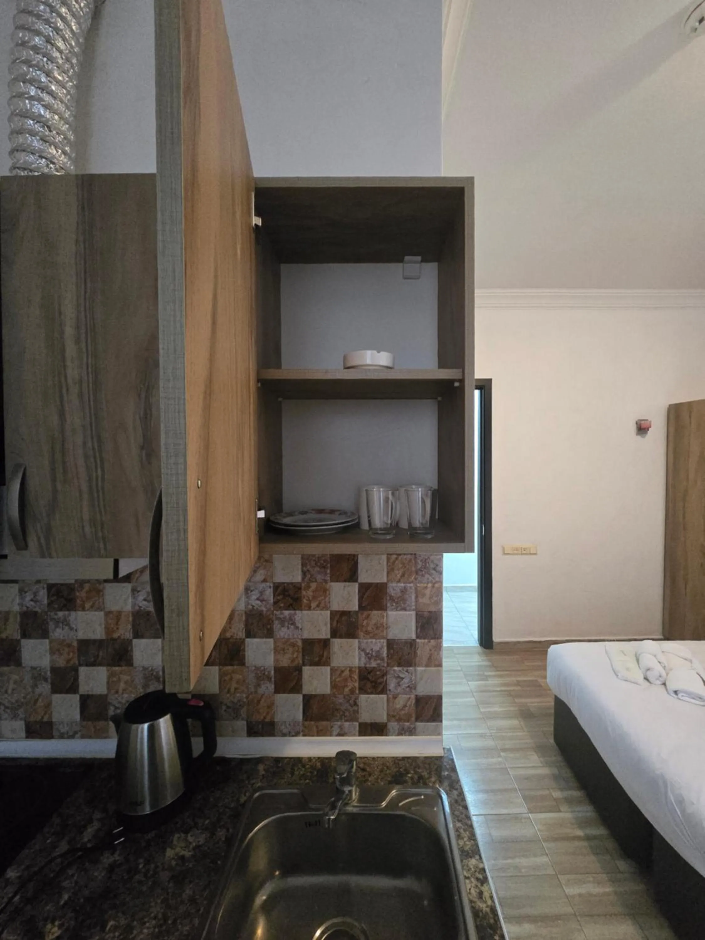 Kitchen or kitchenette, Bed in Batumi Inn Hotel