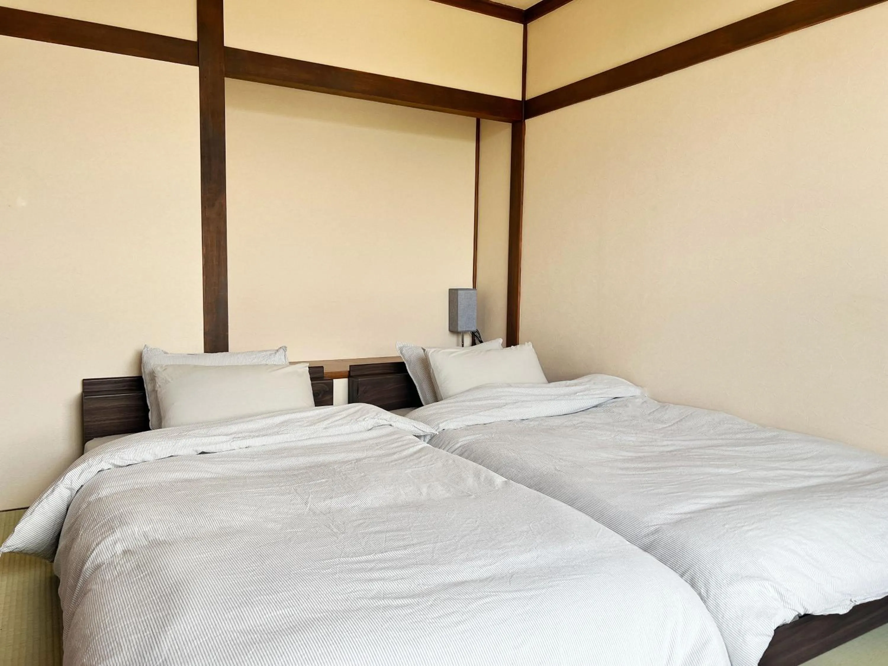Bed in Jinya Sunset Inn by Murasaki