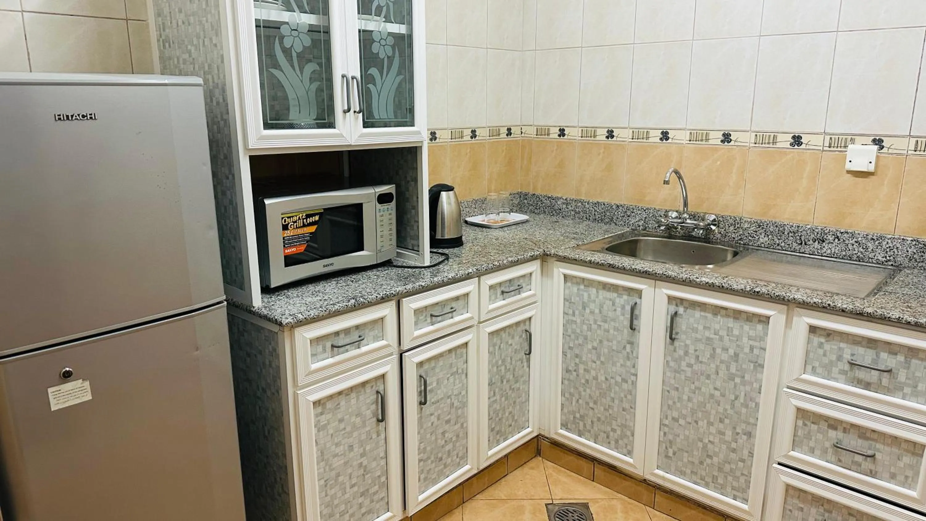 Kitchen or kitchenette in Dahlia Sohar Hotel Apartments