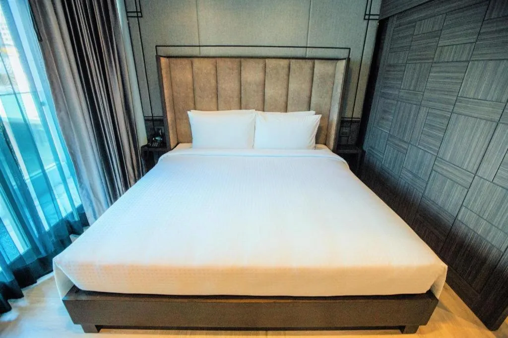 Bed in First Pride Hotel Bangkok