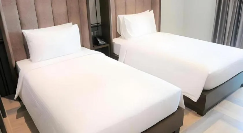 Bed in First Pride Hotel Bangkok