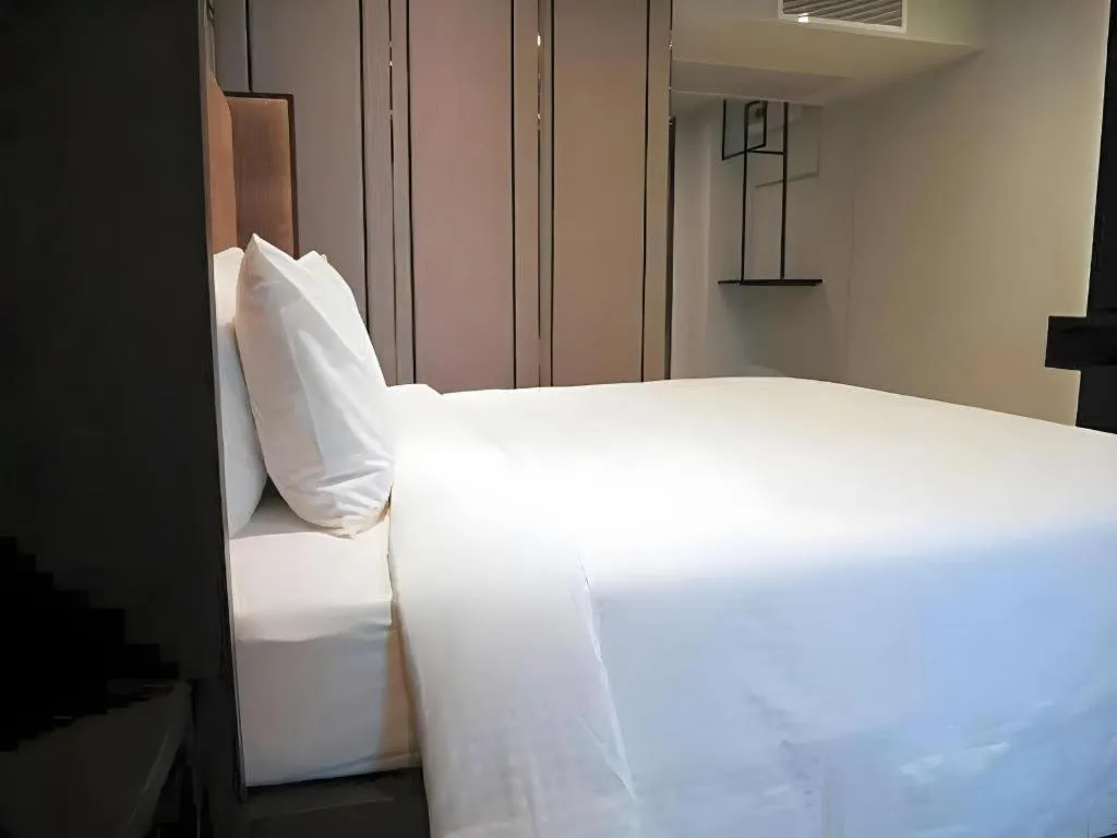 Bed in First Pride Hotel Bangkok