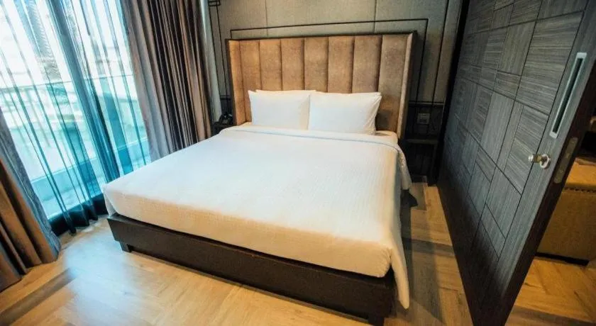 Bed in First Pride Hotel Bangkok