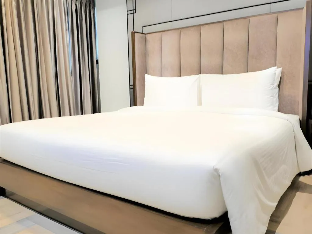 Bed in First Pride Hotel Bangkok