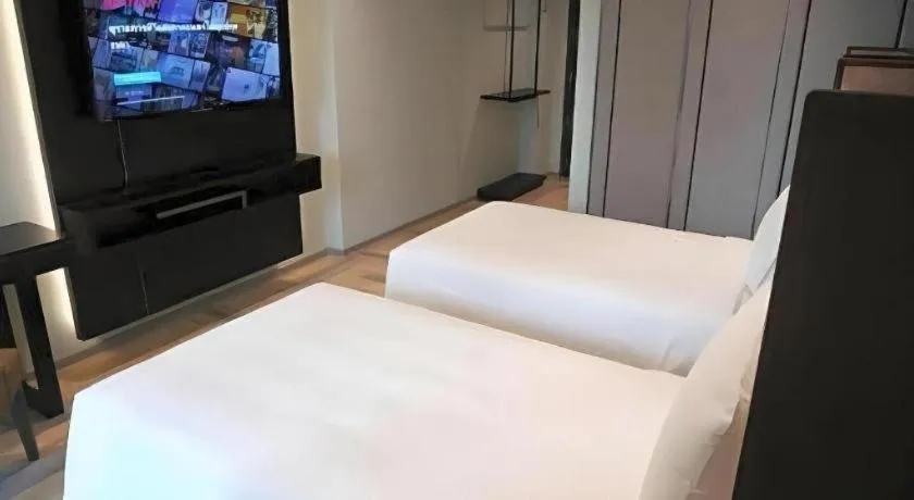 Bed in First Pride Hotel Bangkok