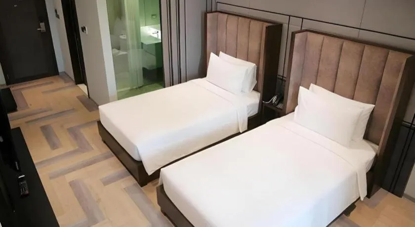 Bed in First Pride Hotel Bangkok