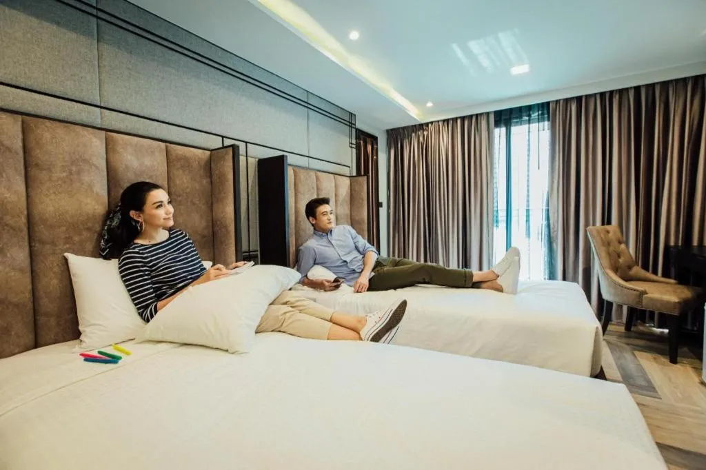 Bed in First Pride Hotel Bangkok