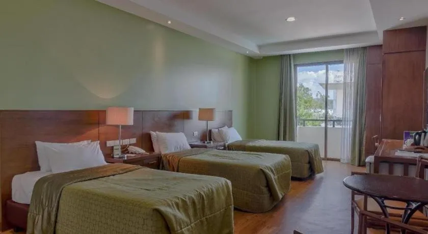 Bed in Mansion Garden Hotel