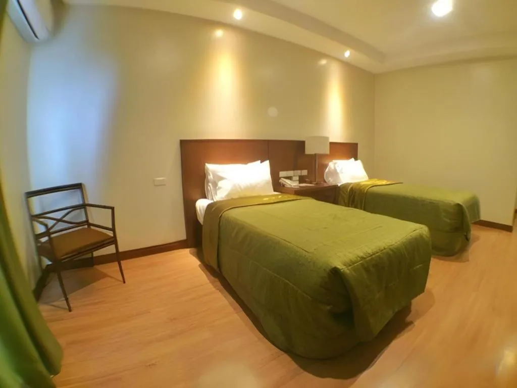 Bed in Mansion Garden Hotel