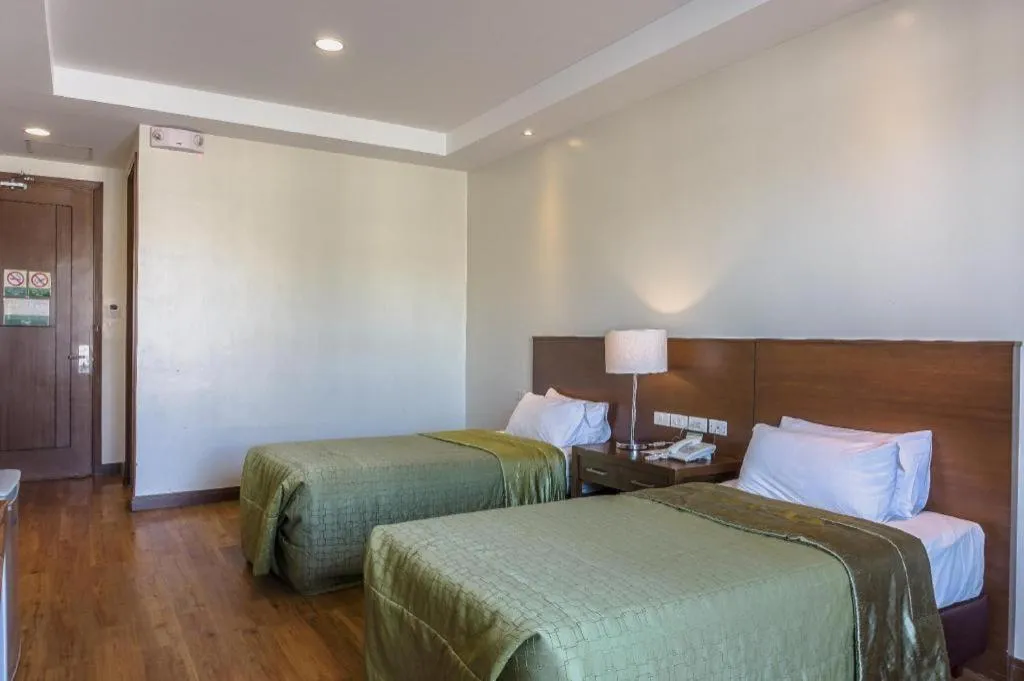 Bed in Mansion Garden Hotel