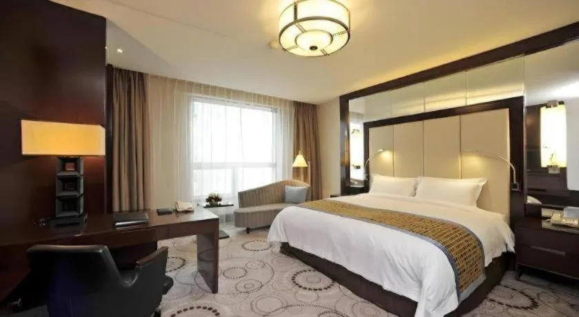 Bed in Grand Soluxe Zhongyou Hotel