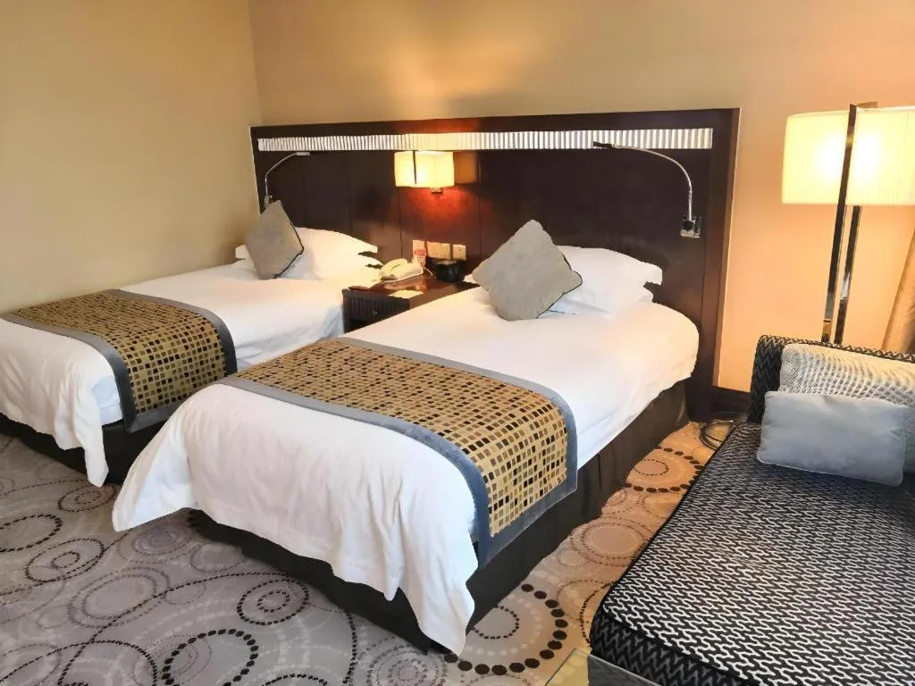Bed in Grand Soluxe Zhongyou Hotel