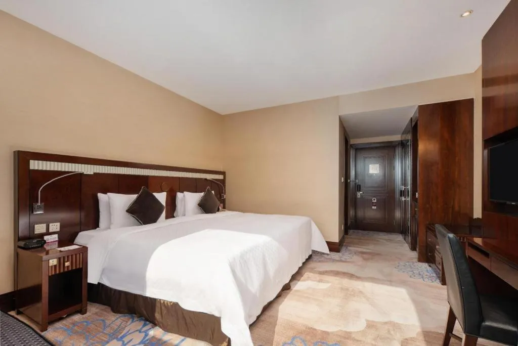 Bed in Grand Soluxe Zhongyou Hotel