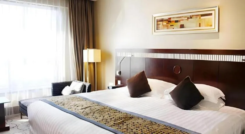 Bed in Grand Soluxe Zhongyou Hotel