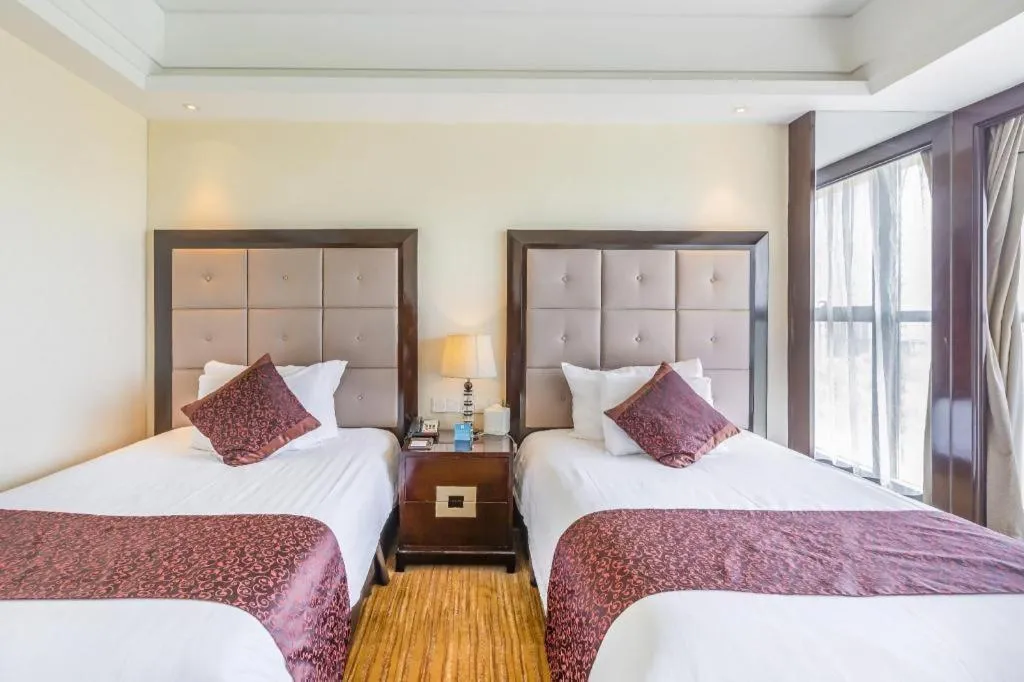 Bed in New Century Grand Hotel Xinxiang