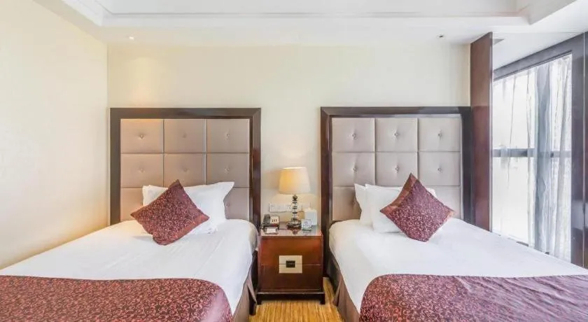 Bed in New Century Grand Hotel Xinxiang