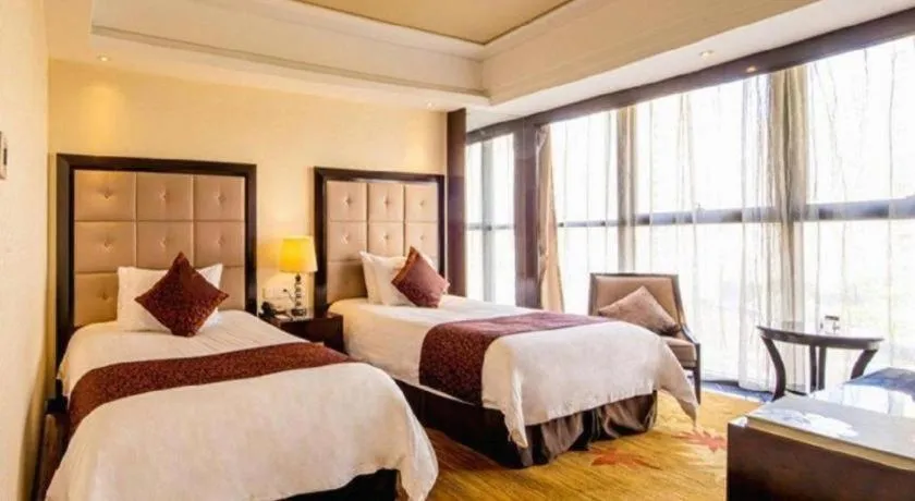 Bed in New Century Grand Hotel Xinxiang