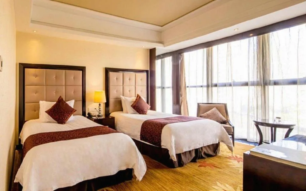 Bed in New Century Grand Hotel Xinxiang
