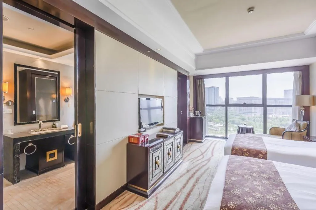 Bed in New Century Grand Hotel Xinxiang