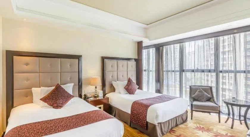 Bed in New Century Grand Hotel Xinxiang