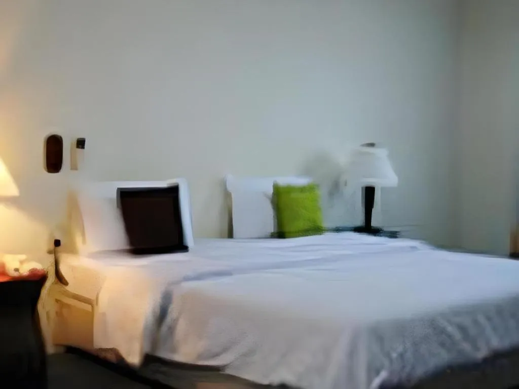 Bed in The Majestic Sakon Nakhon Hotel