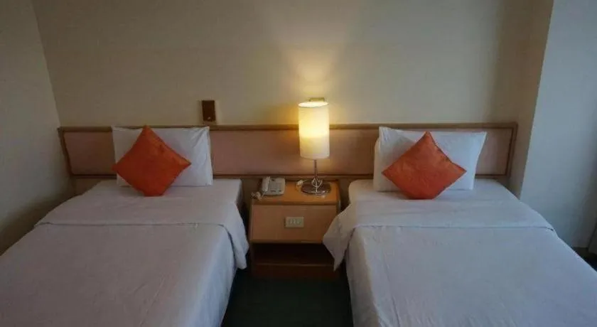 Bed in The Majestic Sakon Nakhon Hotel