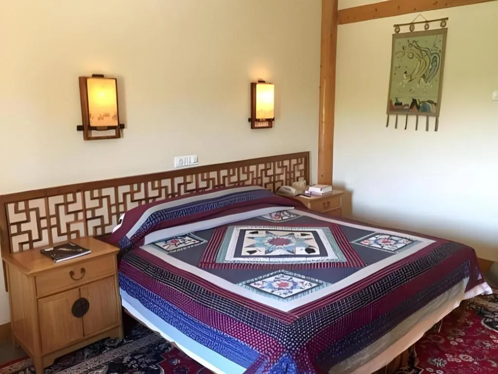 Bed in The Silk Road Dunhuang Hotel