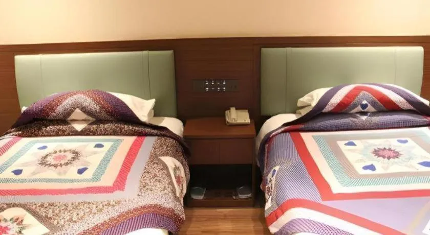 Bed in The Silk Road Dunhuang Hotel