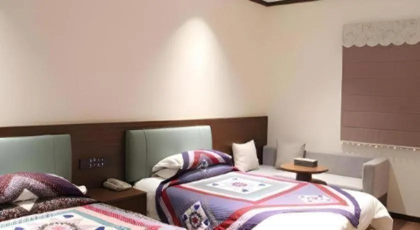 Bed in The Silk Road Dunhuang Hotel