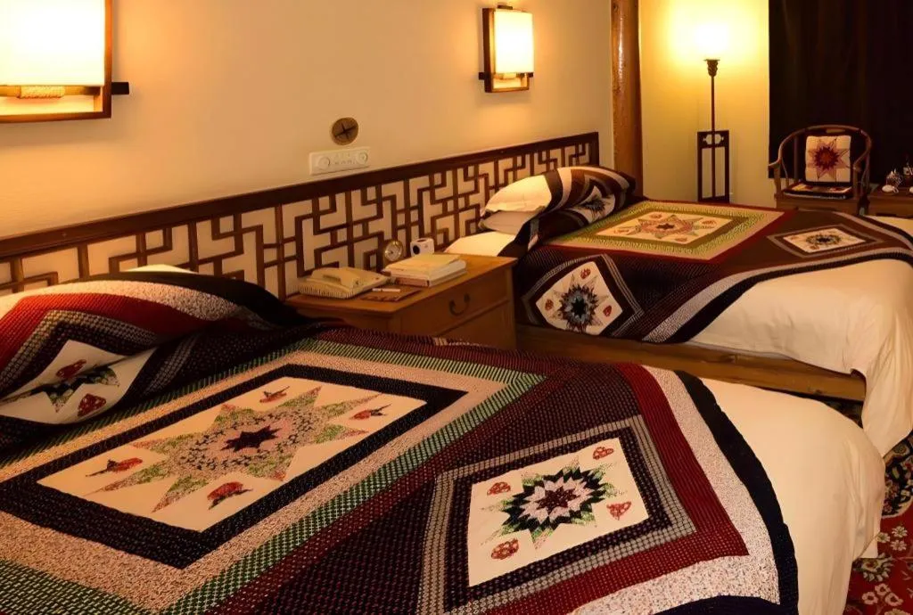 Bed in The Silk Road Dunhuang Hotel