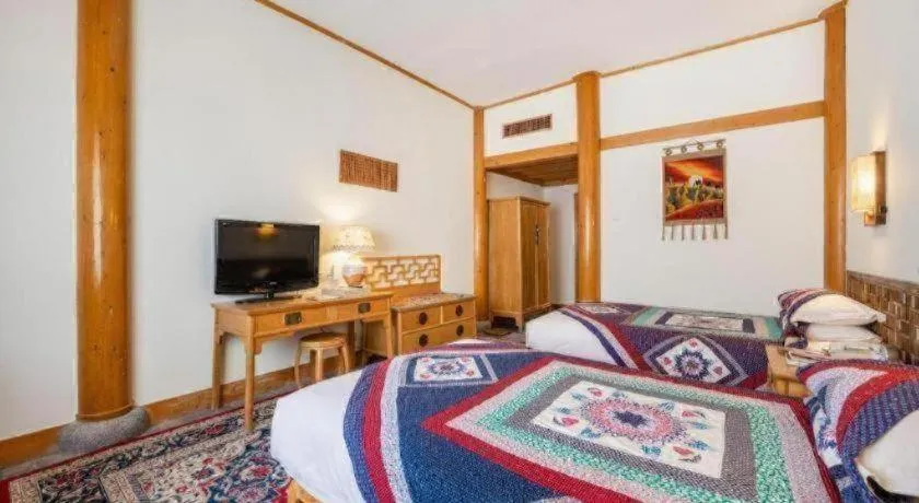 Bed in The Silk Road Dunhuang Hotel