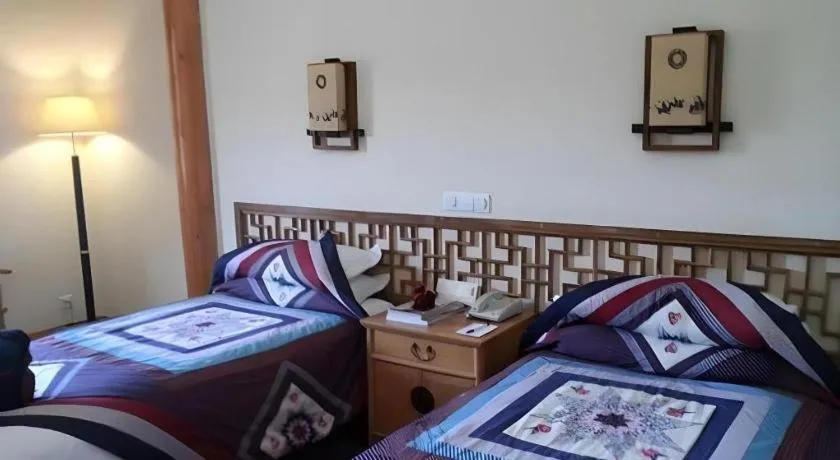 Bed in The Silk Road Dunhuang Hotel