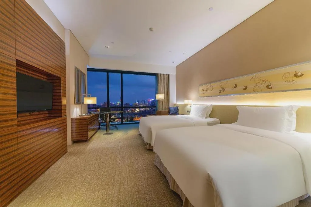 Bed in New World Guiyang Hotel