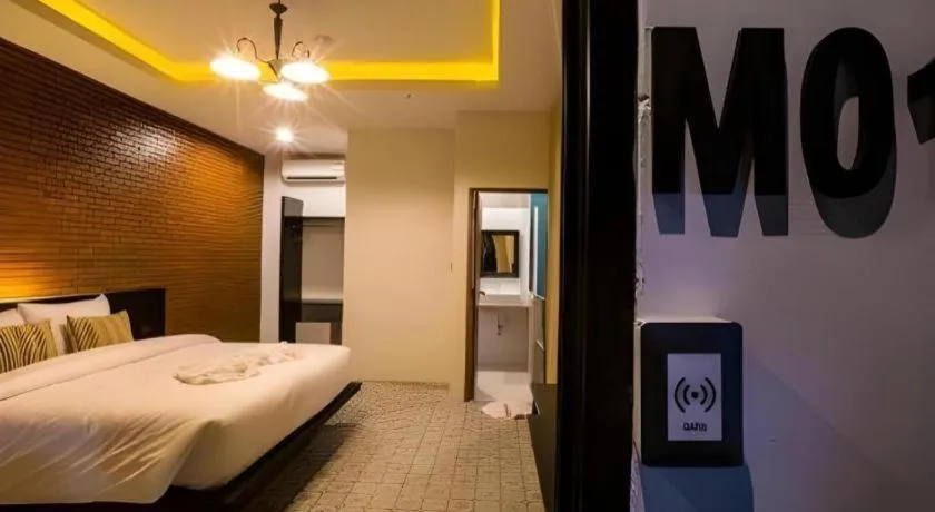 Bed in M Boutique Resort