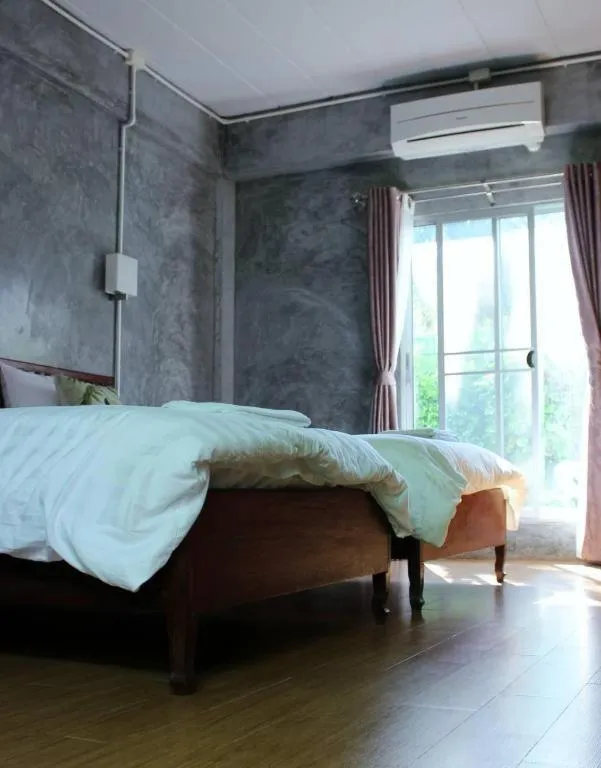 Bed in Rommai Rimnaam Resort