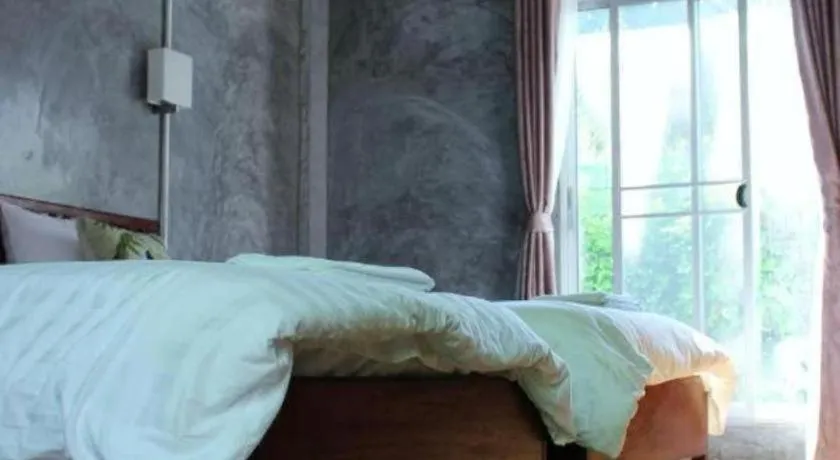 Bed in Rommai Rimnaam Resort