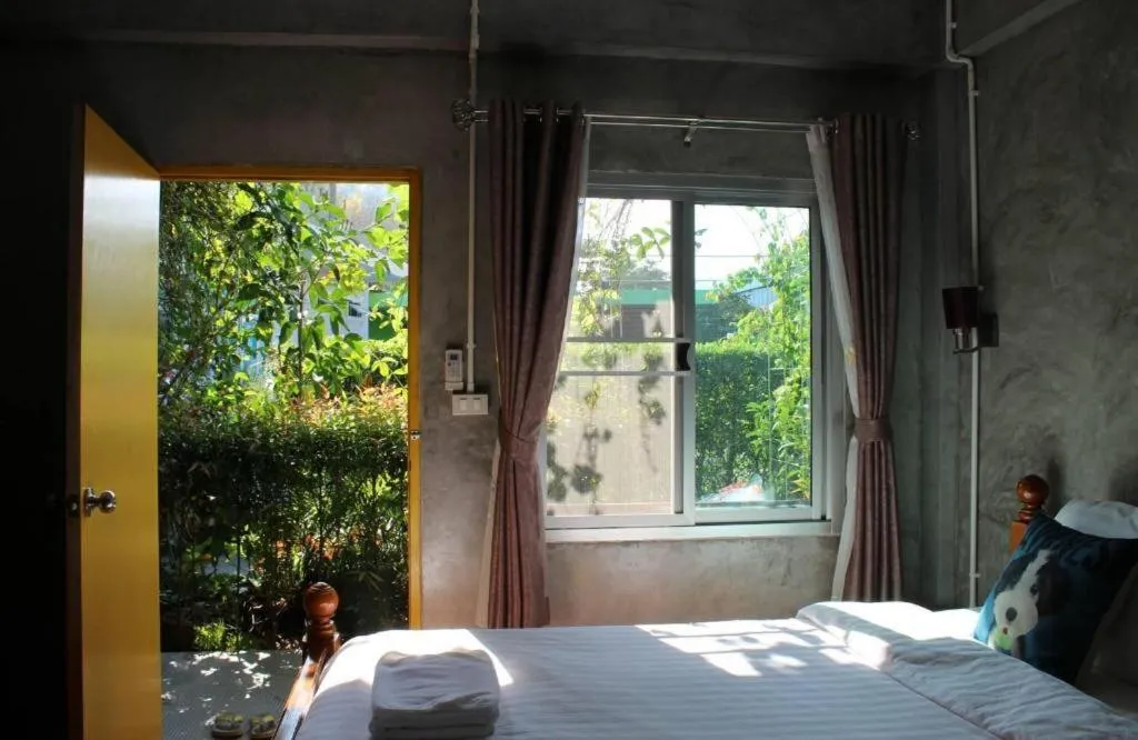 Bed in Rommai Rimnaam Resort