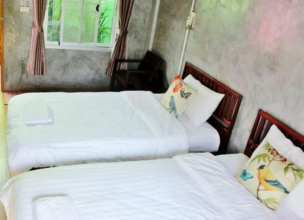Bed in Rommai Rimnaam Resort