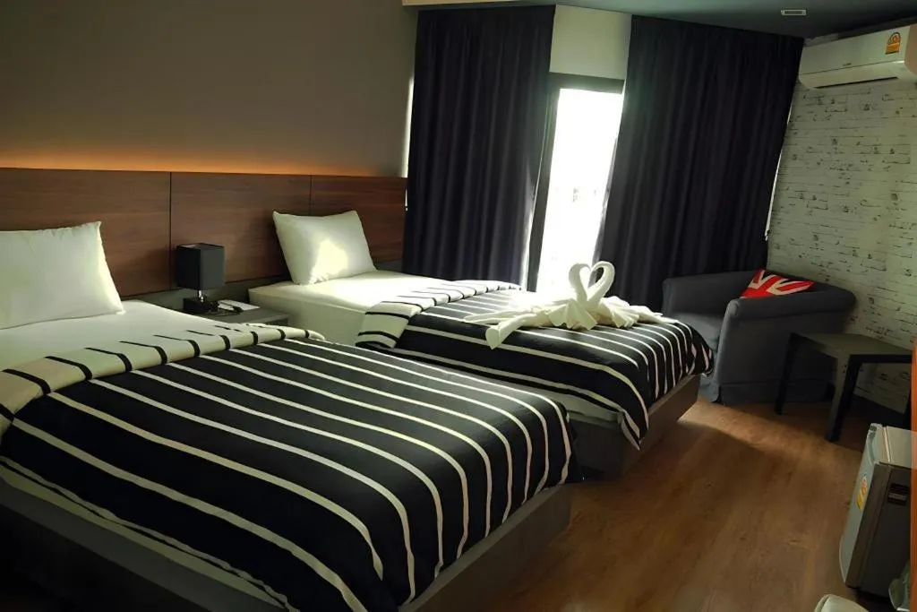 Bed in The Loft Seaside Sriracha Hotel